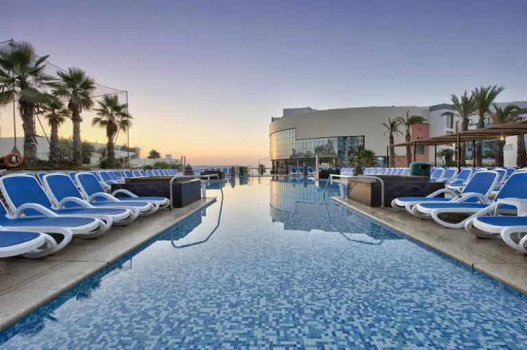 Outdoor pool with sea view at the DB San Antonio Hotel & Spa.