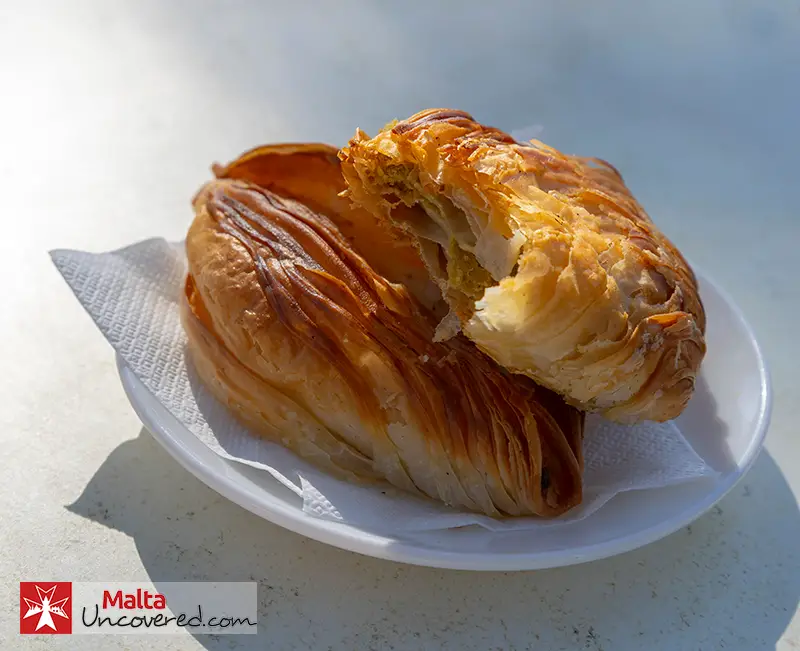 Freshly baked pastizzi: A traditional street food snack in Malta.