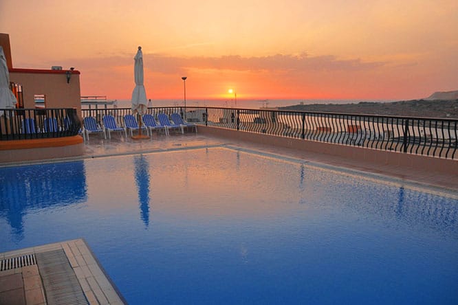 Het zwembad op het dak van het Soreda Hotel bij zonsondergang.