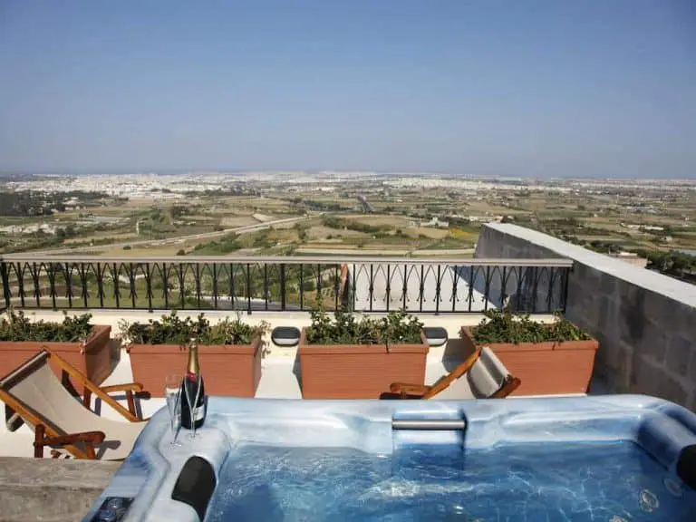 Luxury at the Xara Palace: A terrace with jacuzzi overlooking half of Malta.